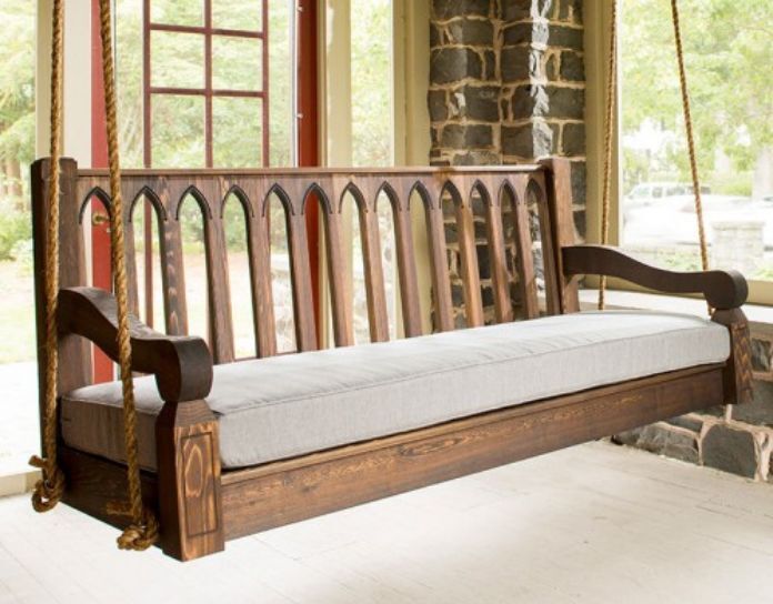 classic wooden front porch swing with ropes
